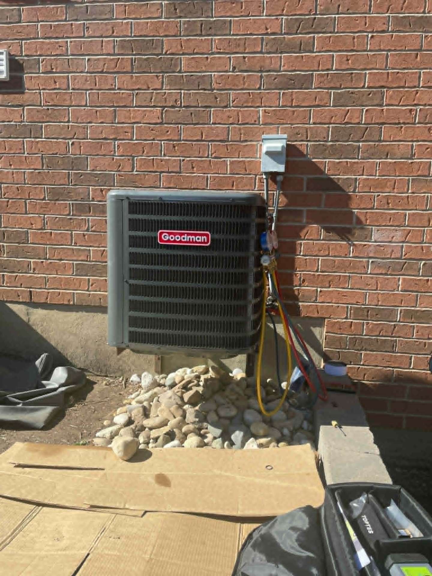 New Goodman central air conditioner commissioned and charged on a sunny day